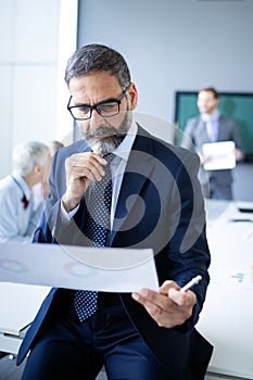 Confident senior businessman leader working in office