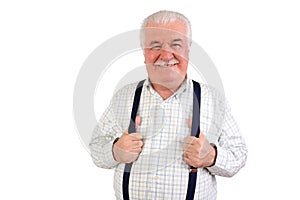 Confident senior man holding his suspenders