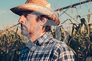 Confident serious farmer portrait in corn field