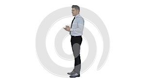 Confident serious smart businessman having an idea and making notes on white background.