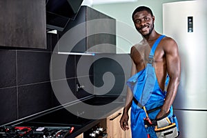 Confident Sexy Shirtless African Posing In Kitchen, Looking At Camera Cheerfully