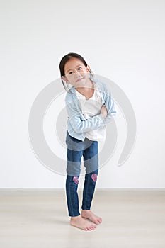 Confident and smart asian little girl crossed arms with happy and face smiling looking at camera