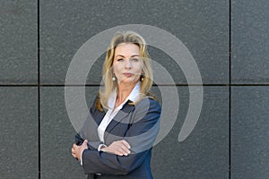 Confident smart businesswoman with folded arms