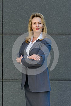 Confident smart businesswoman with folded arms