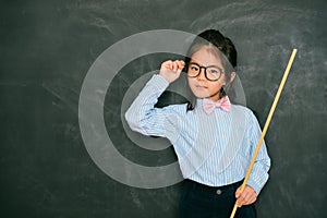 Confident smart little girl dressed as teacher