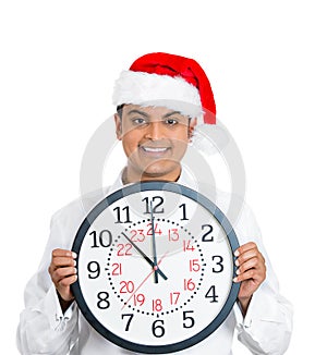 Confident, smart young xmas man holding clock