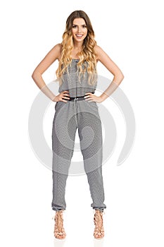 Confident Smiling Fashion Model In Jumpsuit And High Heels