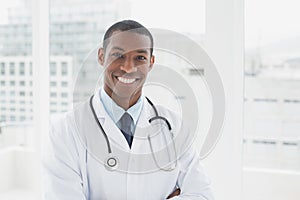 Confident smiling male doctor in a medical office