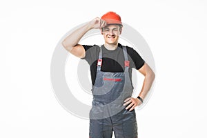 Confident and smiling manual worker with helmet posing isolated on white background