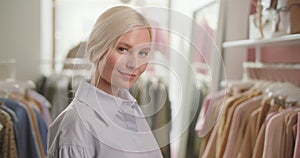 Confident smiling woman retail seller, entrepreneur, clothing store small business owner, looking at camera