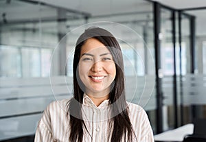 Confident smiling young Asian business woman in office, headshot portrait.