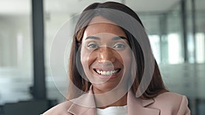 Confident smiling young business woman standing in office, portrait.