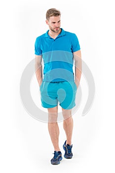 Confident sportsman. Full length handsome fit man in blue sports clothing and sneakers isolated white background