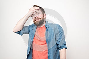 Confident, strong man clenched big fists, looked fearlessly and was about to defend himself, on a white background