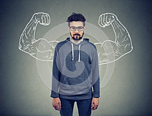 Confident strong man hipster on wall background