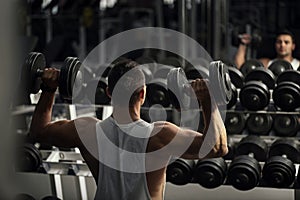 Confident strong weightlifter having a workout