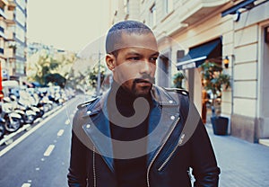 Confident stylish african american man wearing black leather jacket outdoor. Street wear fashion black man