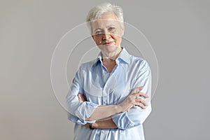 Confident stylish european middle aged senior woman. Older mature 60s lady smiling in white background. Happy attractive