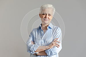 Confident stylish european middle aged senior woman. Older mature 60s lady smiling in white background. Happy attractive