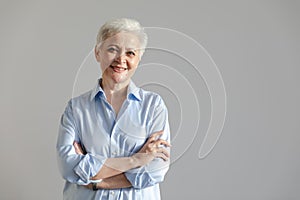 Confident stylish european middle aged senior woman. Older mature 60s lady smiling in white background. Happy attractive