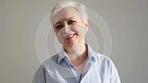 Confident stylish european middle aged senior woman. Older mature 60s lady smiling in white background. Happy attractive