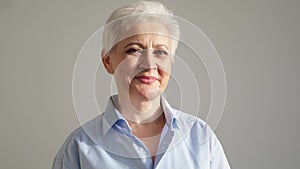 Confident stylish european middle aged senior woman. Older mature 60s lady smiling in white background. Happy attractive