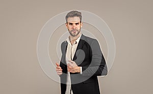 Confident and stylish. sexy ceo on gray background. modern office life. charismatic business owner. stylish realtor