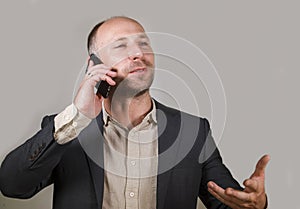 Confident successful businessman talking on mobile phone having business conversation with cellphone smiling cheerful in corporate