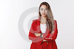 Confident successful good-looking skillfull female entrepreneur wearing red jacket cross arms over chest smiling