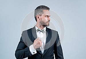 Confident and successful man in tuxedo bow tie on formal event, esthete