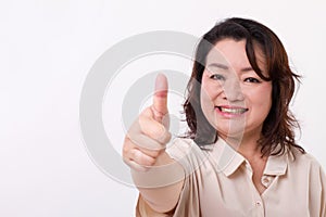 Confident, successful middle aged woman showing thumb up