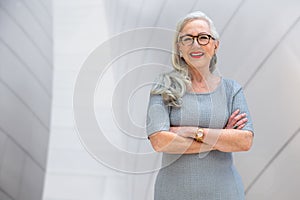 Confident successful portrait of an older senior business woman, company owner, founder, CEO of financial corporation