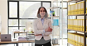 Confident successful professional business woman standing with crossed arms in office