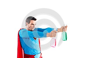 confident superhero holding plastic spray bottles with cleaning liquid and looking away