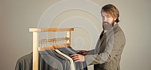 Confident tailor designing male jacket. handsome sartor with tape measure. male beauty and fashion. bearded man photo