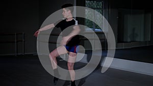 Confident talented male ballet dancer spinning jumping sitting down raising hands. Portrait of concentrated Caucasian
