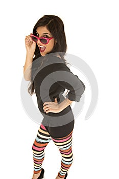 Confident tan woman wearing colorful leggings red sunglasses