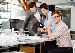 Confident team of engineers working together in a architect studio.