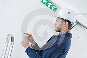 Confident technician connecting with digital tablet and using apps
