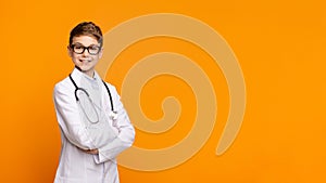 Confident teen doctor with stethoscope posing with arms crossed