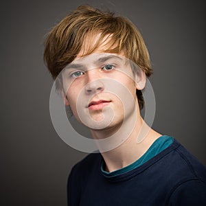 Confident Teenage Blond Young Man In The Studio