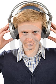 Confident teenage boy listening to music