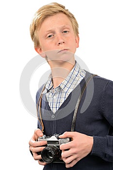 Confident teenage boy with retro camera