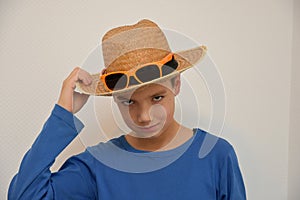 Confident teenager with straw hat and sunglasses photo