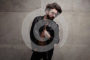 Confident trendy man in leather jacket