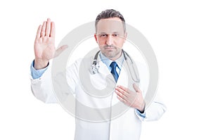 Confident and trustworthy medic or doctor making Hippocratic oat photo