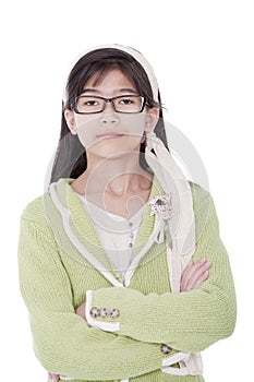 Confident, unsmiling girl in green sweater and glasses