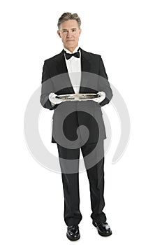 Confident Waiter With Serving Tray Standing Against White Background