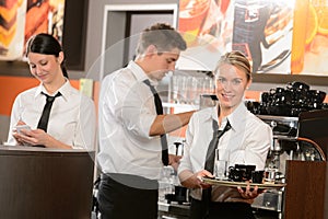 Confident waitresses and waiter working in bar