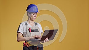 Confident woman browsing internet on laptop pc